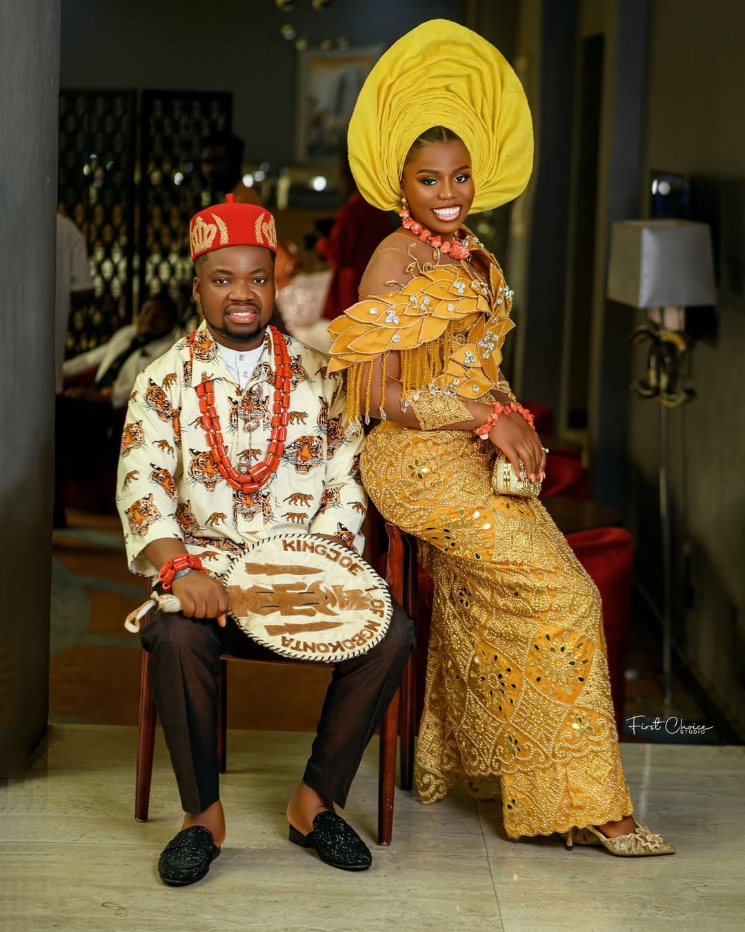 Seated couple in gold traditional attire