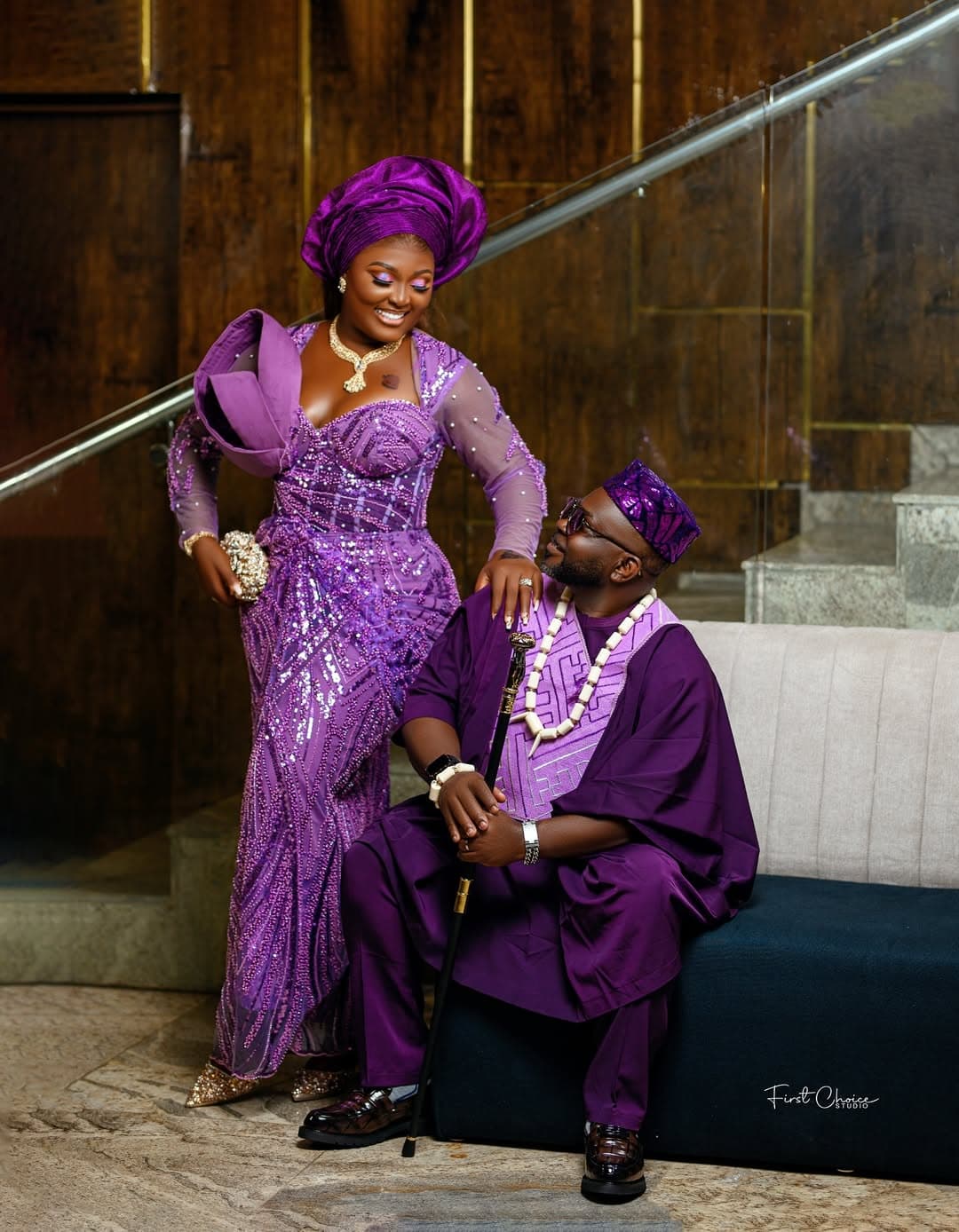 Purple aso-oke couple on staircase