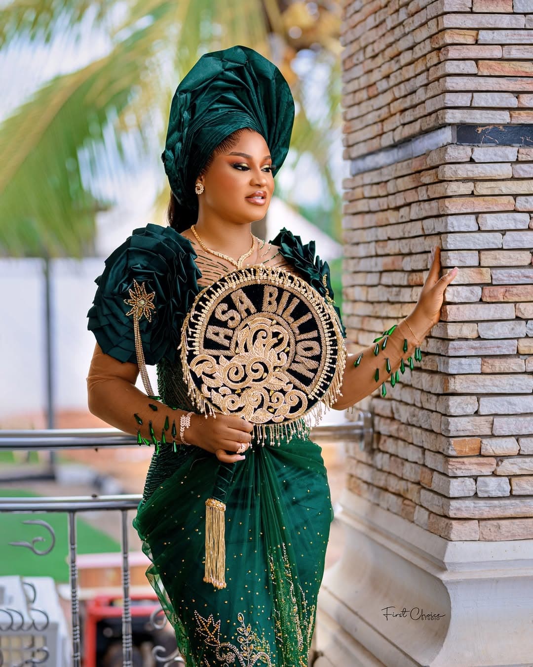 Bride in green with traditional fan