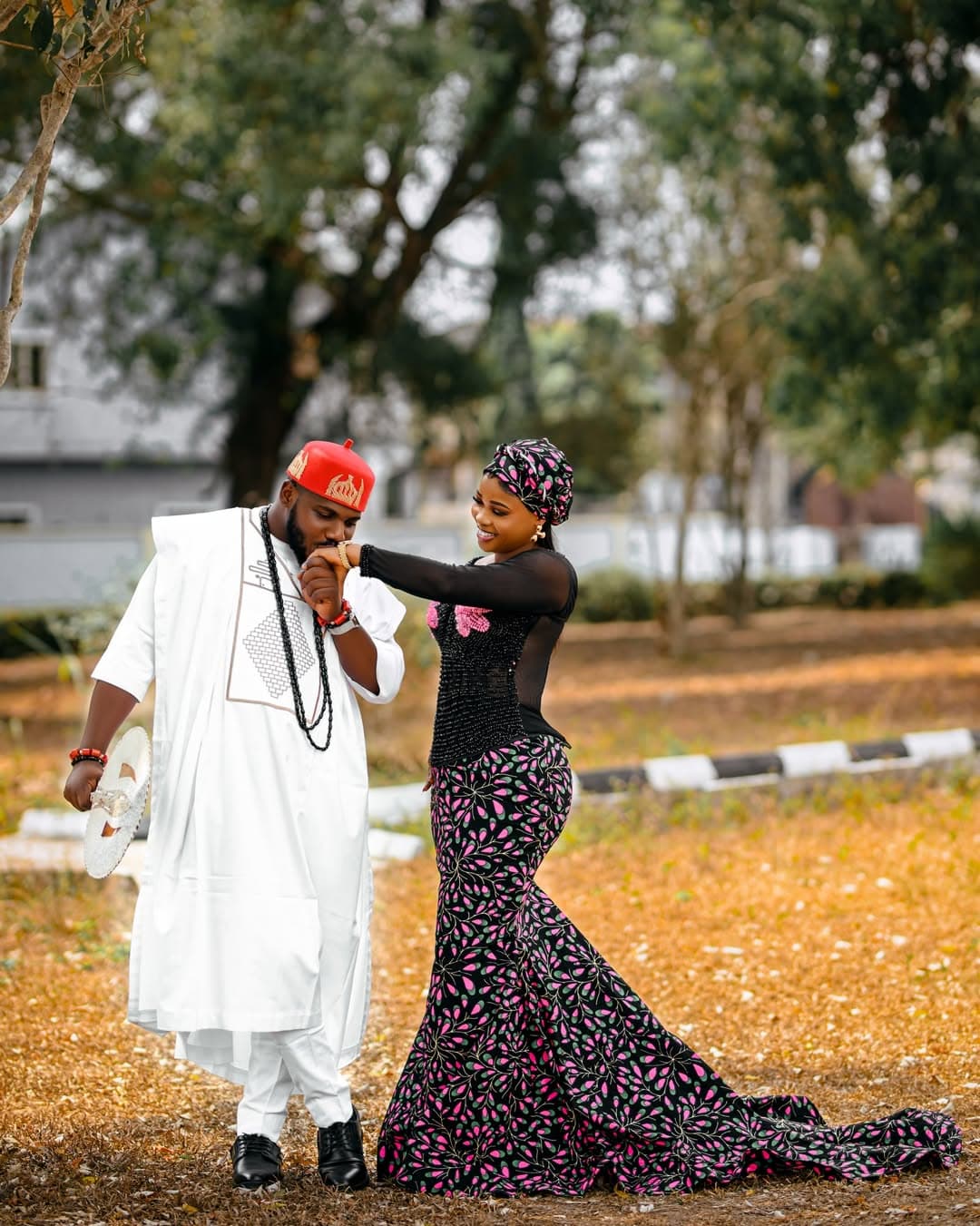 Couple sharing a hand kiss in white and patterned traditional wear