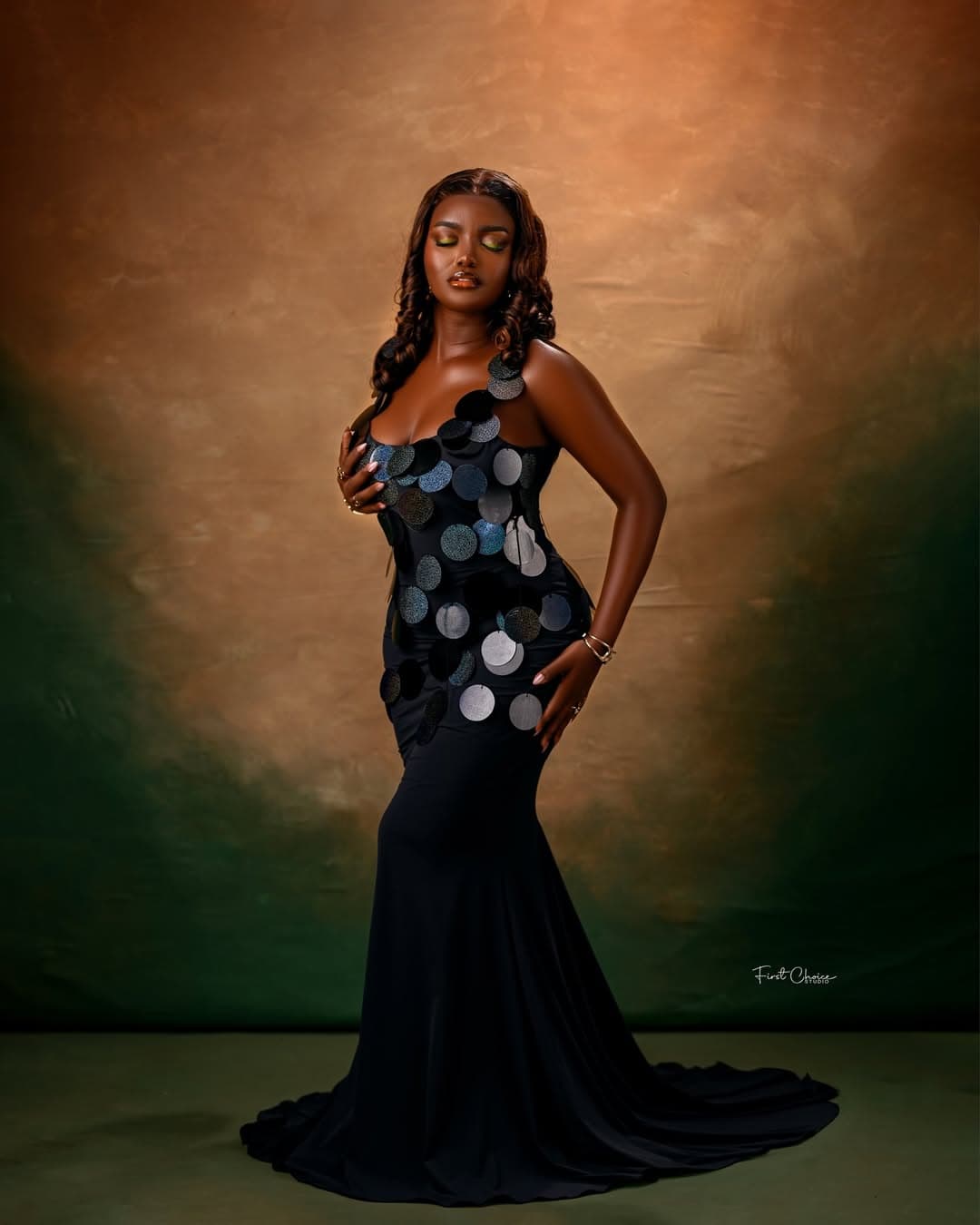 Standing studio portrait in a black gown